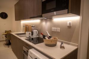a kitchen with a basket of utensils on a counter at Urban Nook, The Bantree in Accra