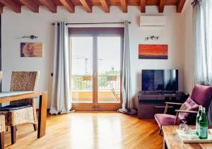 a living room with a large window and a tv at Villa Mattei Franciacorta in Villa Pedergnano