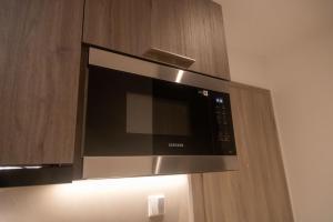 een magnetron is bevestigd aan een muur bij Urban Nook, The Bantree in Accra