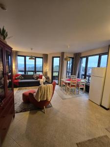 a living room with a couch and a table at Tranquility Apartment Pirin Golf in Razlog