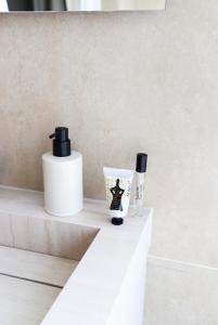two bottles ofodorizers sitting on a counter in a bathroom at Dam Residence Boutique Hotel Amsterdam - Zaandam in Zaandam +29 photos