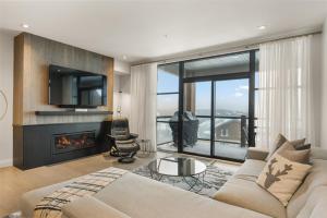 a living room with a couch and a fireplace at Tremblant Prestige - Horizon 2-204 in Mont-Tremblant +26 photos