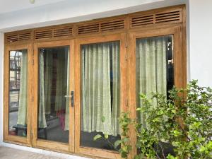 a wooden door with windows in a house at Rooftop Shantiniketon in Dhaka