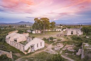 Casa Diamante Hotel Boutique - Mineral de Pozos في Mineral de Pozos: اطلالة جوية على مبنى قديم في ميدان