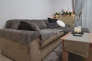 a living room with a couch and a table at Heleni's Apartment in Aridaia +14 photos