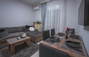 ein Wohnzimmer mit Sofa und Tisch in der Unterkunft Heleni's Apartment in Aridea