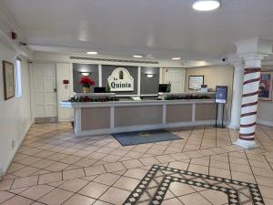 a lobby with a waiting room with a counter at La Quinta by Wyndham Pinellas Park St Peterburg Clearwater in Pinellas Park +26 photos
