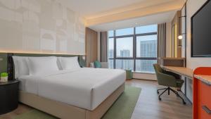 a hotel room with a bed and a desk at EVEN Hotel Chengdu Phoenix Mountain by IHG in Chengdu +49 photos