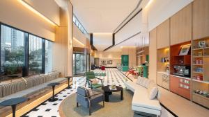 a living room with a couch and chairs at EVEN Hotel Chengdu Phoenix Mountain by IHG in Chengdu
