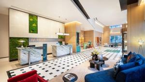 a lobby of a building with blue couches at EVEN Hotel Chengdu Phoenix Mountain by IHG in Chengdu