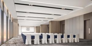 a conference room with a row of tables and chairs at Crowne Plaza Linyi Olympic Sports Centre by IHG in Linyi