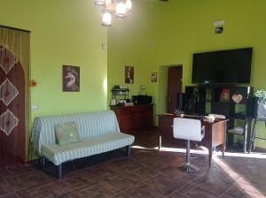 a living room with a couch and a television at TABERNA ROMANA VILLA OCA b&b in Velletri