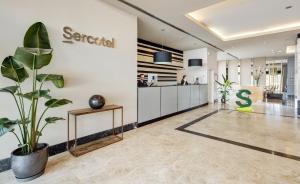 an office with a plant in the middle of a lobby at Sercotel Ciutat de Montcada in Montcada i Reixac