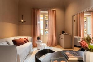 a living room with a couch and a table at Palazzo Balsamo Boutique Hotel in Palermo +87 photos