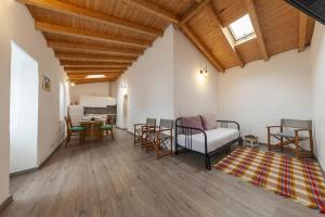 a living room with a couch and a table at A28 - Castela Street Townhouse in Espiche in Luz
