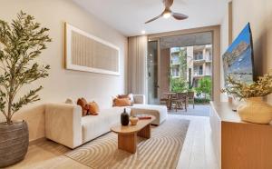 a living room with a white couch and a table at Bohari Las Arenas in Cabo San Lucas