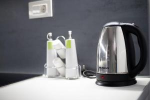 a black tea kettle sitting on a kitchen counter at Perivola apartment in Patra