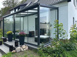 an extension of a house with glass doors at Ferienwohnung-Finn-EG in Rechlin