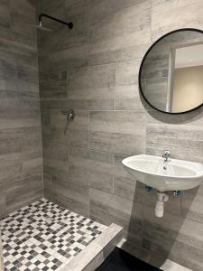 a bathroom with a sink and a mirror at Guesthouse Le Michele in Swakopmund