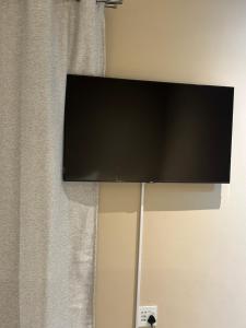 a flat screen tv hanging on a wall at Guesthouse Le Michele in Swakopmund