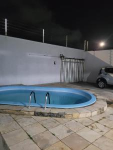 a swimming pool with two faucets in a parking lot at Bela Casa PX as praias in São Luís