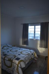 a bedroom with a bed and a window at Villa del Sol Complejo in Liebig
