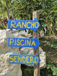 a sign that says rarotonga and sardinia at Beach resort playa Leona in Gigantes +51 photos