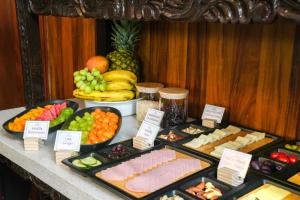 a buffet of different types of food on a table at HC Gatsby Hoteles in Arequipa