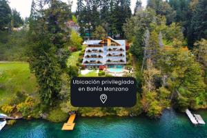 an aerial view of a villa on a lake at El Muelle by DOT Boutique in Villa La Angostura