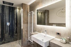 a bathroom with a sink and a shower at Albergo Centrale in San Martino di Castrozza +79 photos