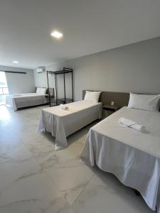 Postel nebo postele na pokoji v ubytování Piúma Palace Hotel