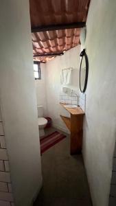 a bathroom with a toilet and a sink and a mirror at Mirante Morere in Moreré +122 photos