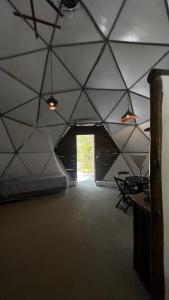 a room with a large tent with a doorway at Mirante Morere in Moreré