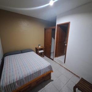 a bedroom with a bed and an open door at Hotel Anturio in Huajuapan de León