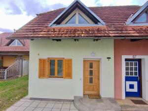 a small white house with a brown roof at Villa Petz in Brežice
