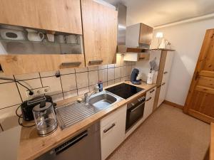 a small kitchen with a sink and a stove at Sophie in Lübeck +5 photos