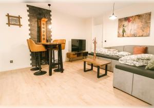 a living room with a couch and a table at 21 Gramm Das Verborgene mit Tiefgarage in Sasbachwalden