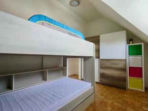 a bedroom with a bunk bed with a ladder at Villa Petz in Brežice