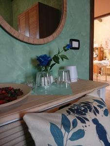 a table with a mirror and a vase with a blue rose at TABERNA ROMANA VILLA OCA b&b in Velletri +62 photos