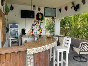 een keuken met een aanrecht en een bar met stoelen bij So Suite, Negril with seaview in Negril
