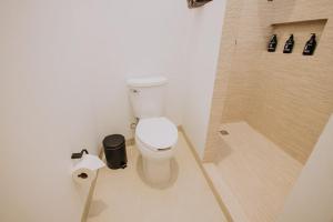 a bathroom with a toilet and a shower at 605 Tower Downtown Cabo in Cabo San Lucas