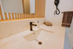 a bathroom with a sink and a mirror at 605 Tower Downtown Cabo in Cabo San Lucas
