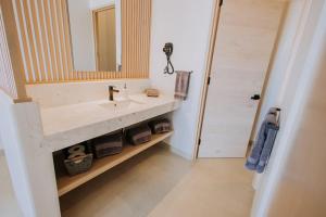 a bathroom with a sink and a mirror at 605 Tower Downtown Cabo in Cabo San Lucas