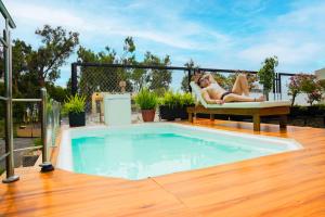 a woman laying in a chair next to a swimming pool at Gya Hoteles in Arequipa