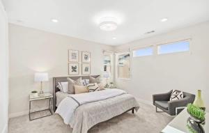 a white bedroom with a bed and a chair at Marbella Lane Chic Stay In Prime Irvine Area in Lake Forest