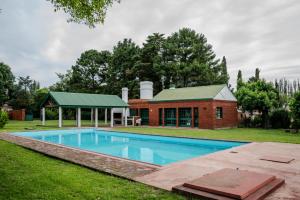 einem Pool vor einem Backsteingebäude in der Unterkunft Casa quinta Cerrito Colorado in Junín