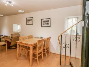 a dining room with a table and chairs at Hay Loft in Anstruther +10 photos
