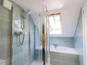 a bathroom with a shower and a tub at Hay Loft in Anstruther