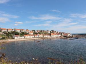 a group of houses on the shore of a body of water at Hay Loft in Anstruther