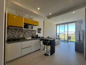 a kitchen with a counter and a couch in a room at Edificio Salinas del Mar - Pozos Colorados in Santa Marta